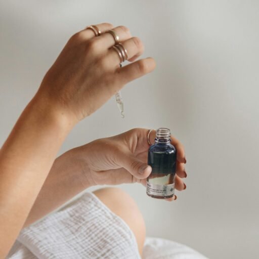 person holding black glass bottle